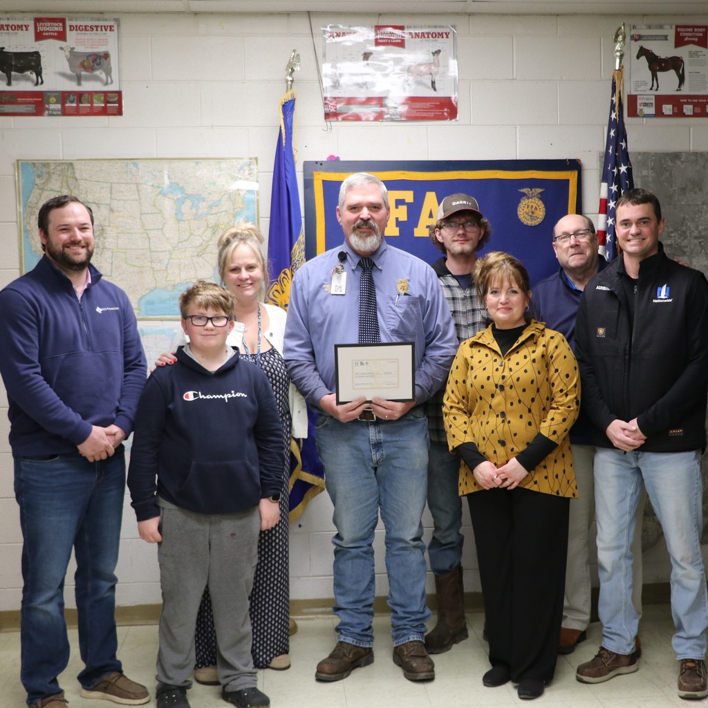 Mr. Viebrock poses for a picture with his family and representatives from FFA and the sponsor companies.