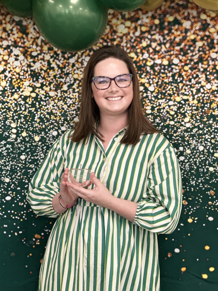 Megan Jermain, Teacher of the Year poses with a crystal apple award