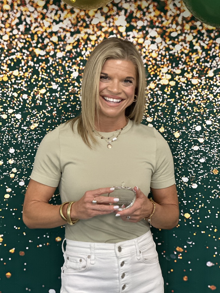 Erika Opperman, Support Staff of the Year poses with a crystal apple award