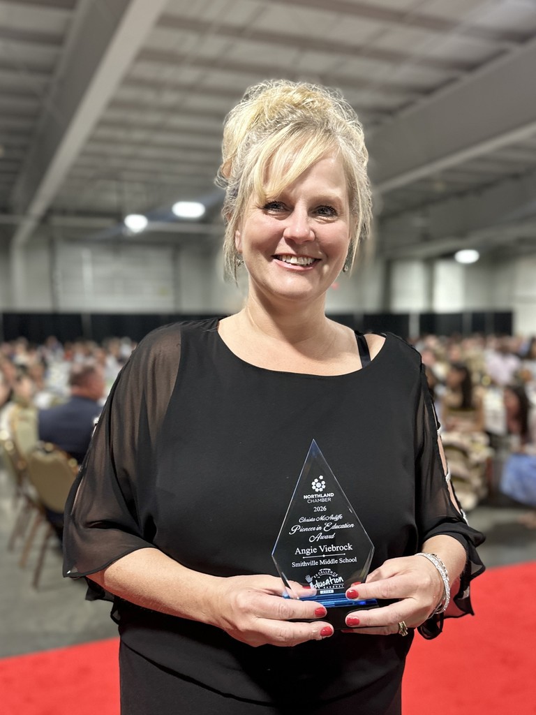 Award Recipient poses with trophy