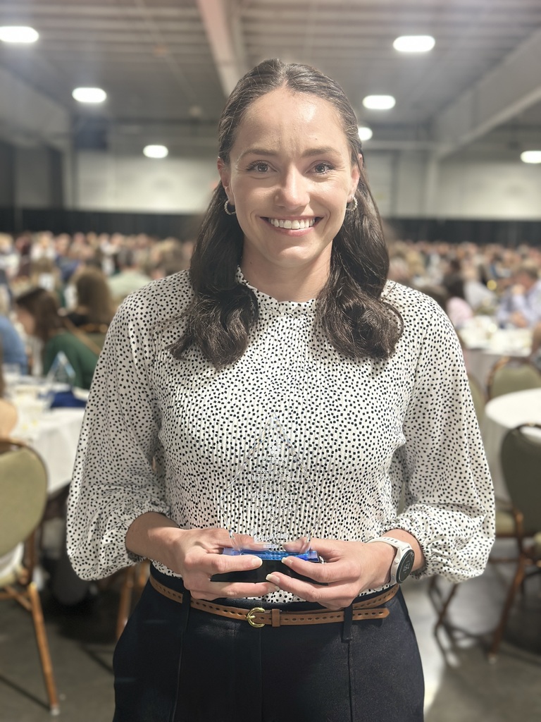 Award Recipient poses with trophy