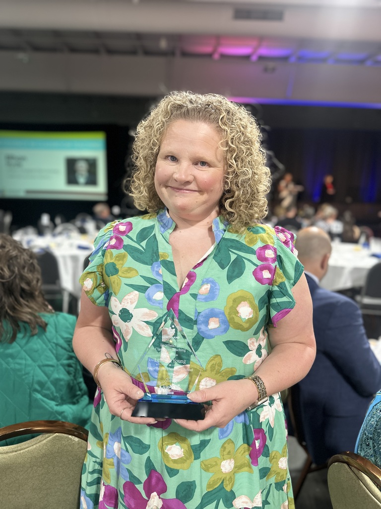 Award Recipient poses with trophy