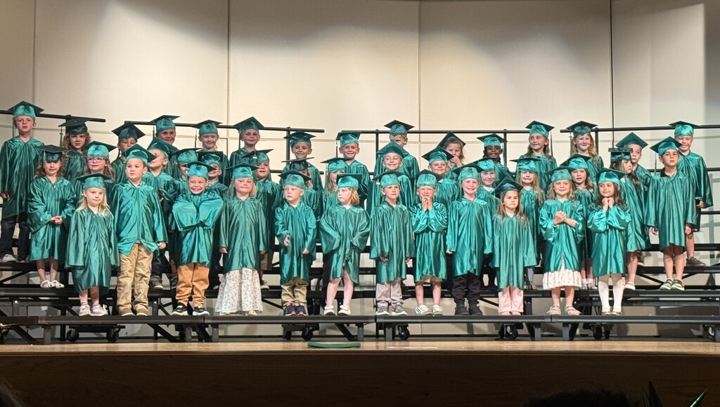 Preschool graduates pose for a picture on the risers.