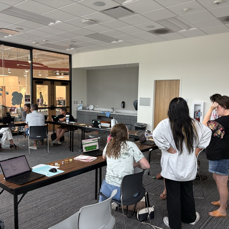 teachers meeting in a small group discussing a topic