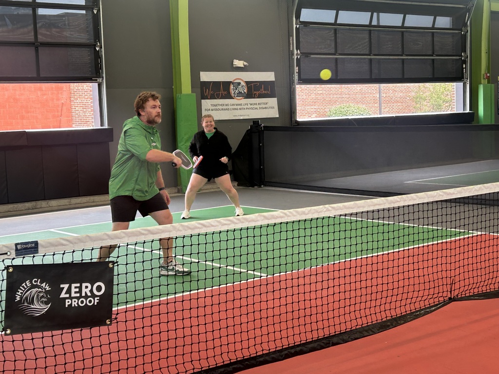 Two people playing Pickleball.