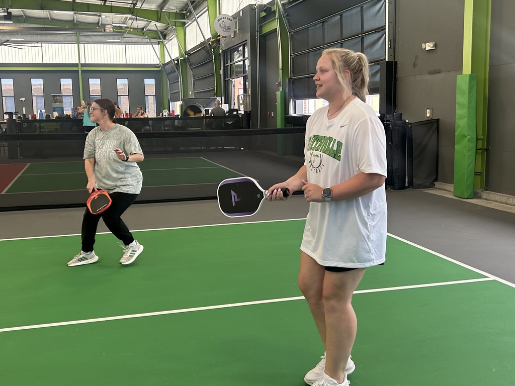 Two people playing pickleball.