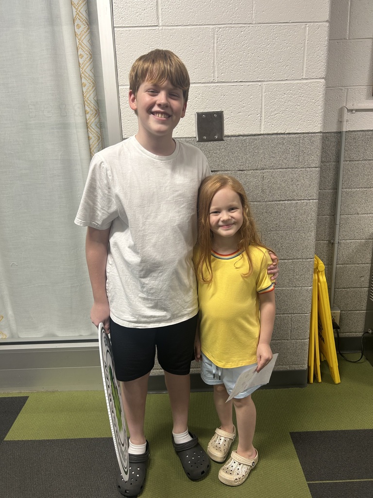 Two students smiling.