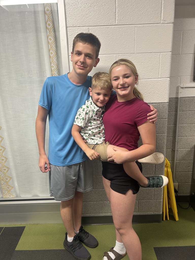 Three students smiling.