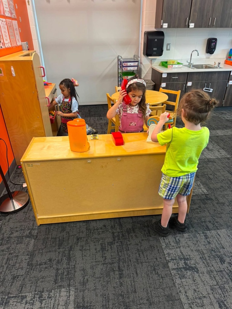 Preschoolers playing at stations