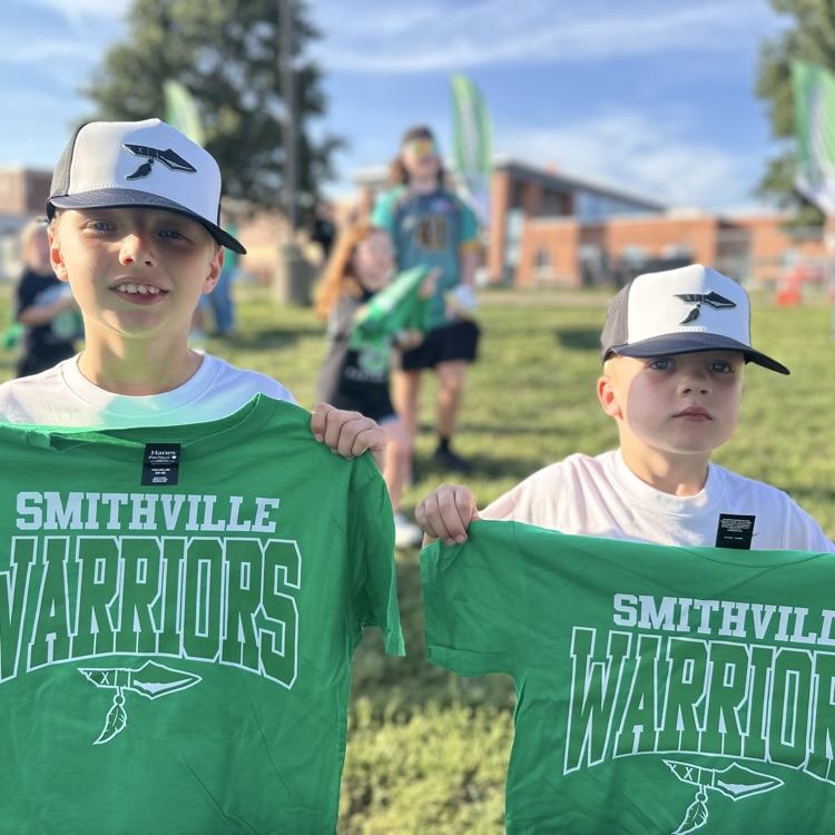 Brothers holding up their warriors shirts