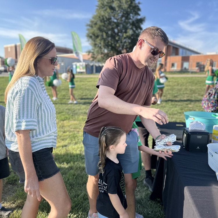 a family going through the line to get hot dogs