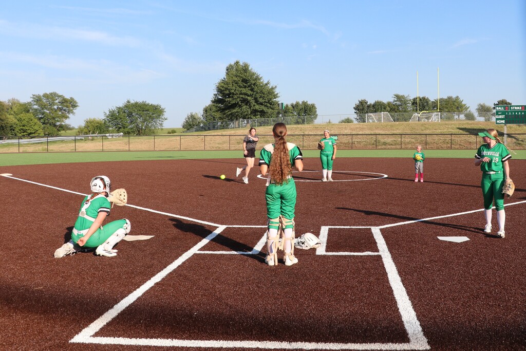 The pitcher representing the past throws her first pitch