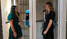 Two girls try out the phone booth at the Missouri State Penitentiary