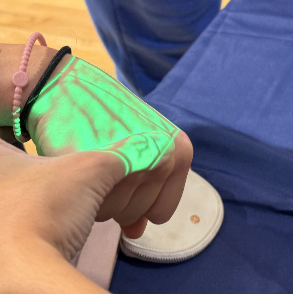 Someone's hand is lit up showing their veins.