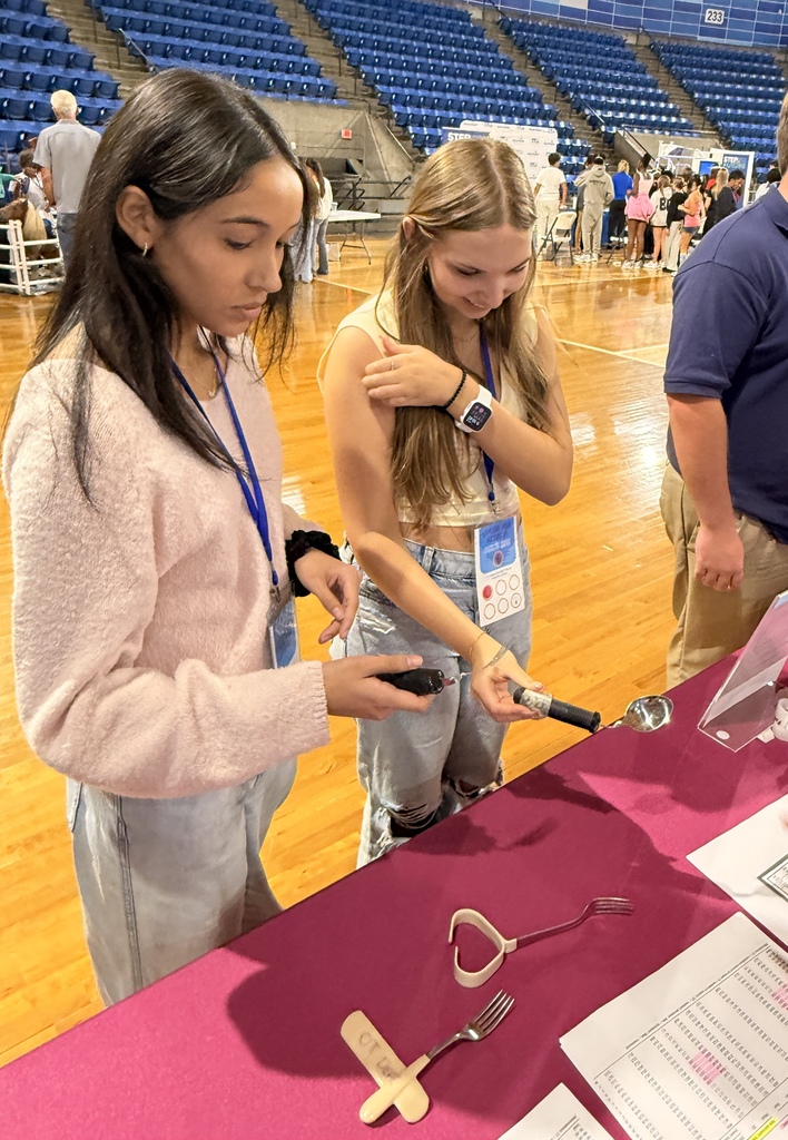 Biomedical students look at medical tools.