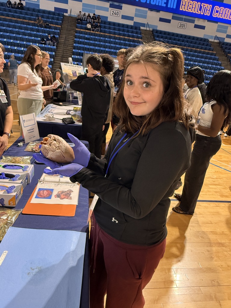 A biomedical student holds a heart.