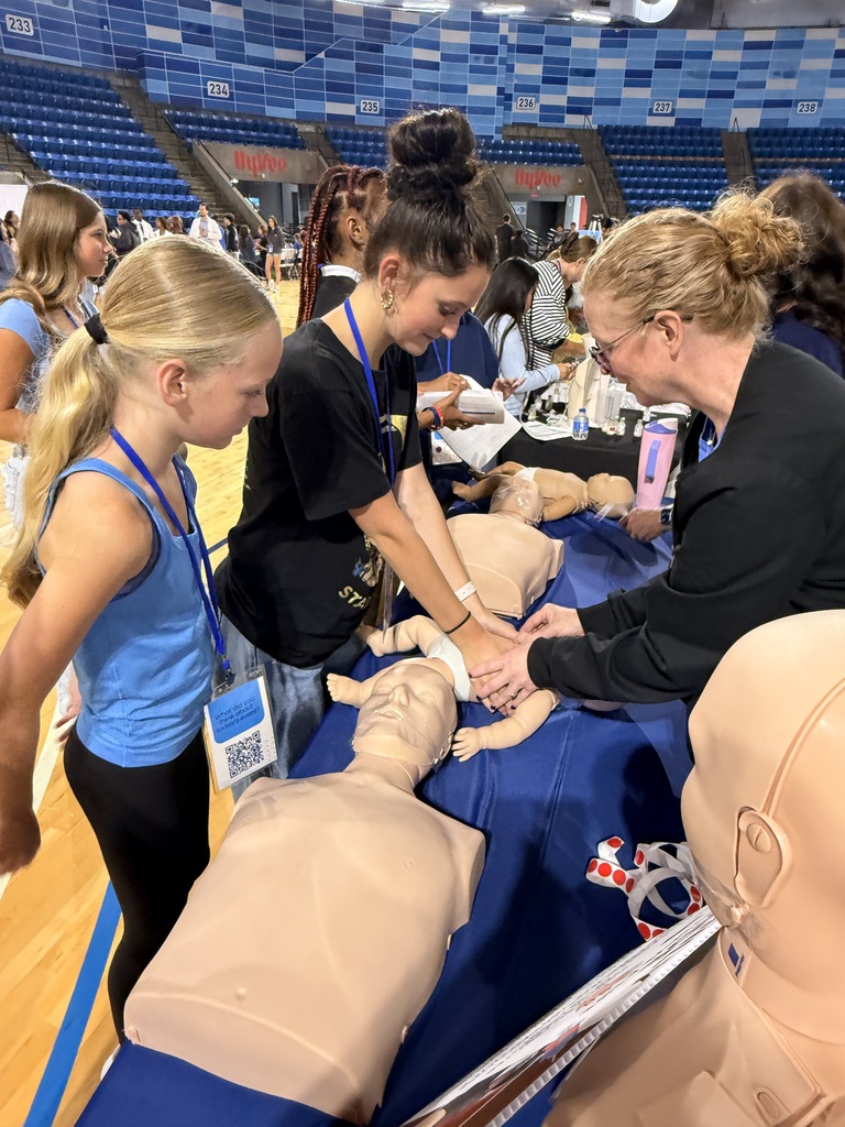 A biomedical student practices cpr on a baby,