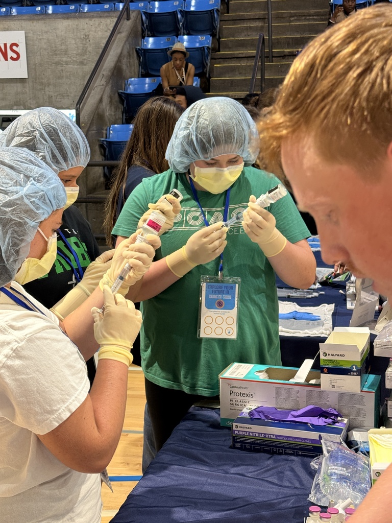 A biomedical student practicing filling a needle.