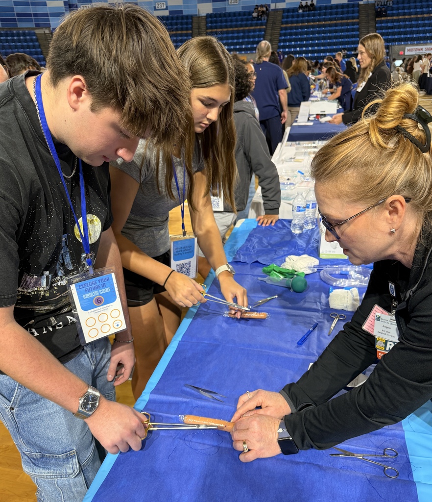 A biomedical student sutures a hot dog.