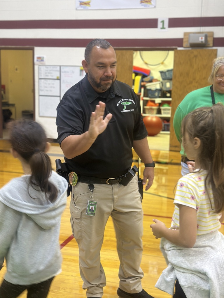 Officer Morales is giving high fives to students
