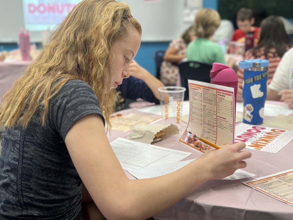 A student looks at the menu to find the price of an item.