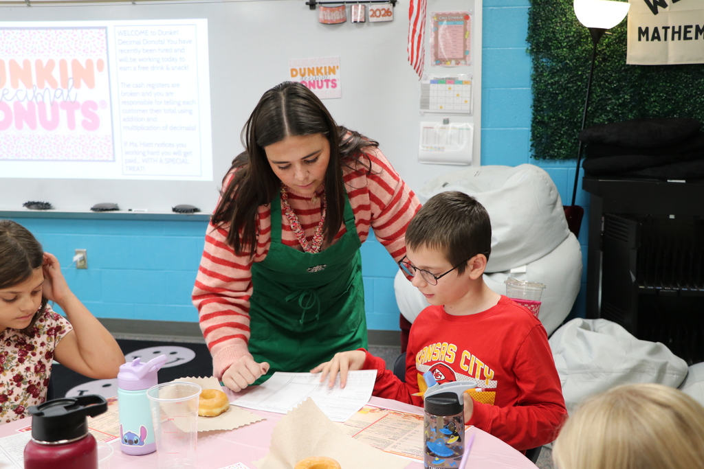 Ms. Hiatt assists a student with thier work.