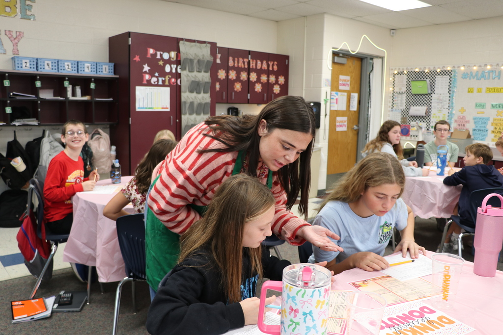 Ms. Hiatt helps a student figure out how to calculate the customer's total during math lesson.