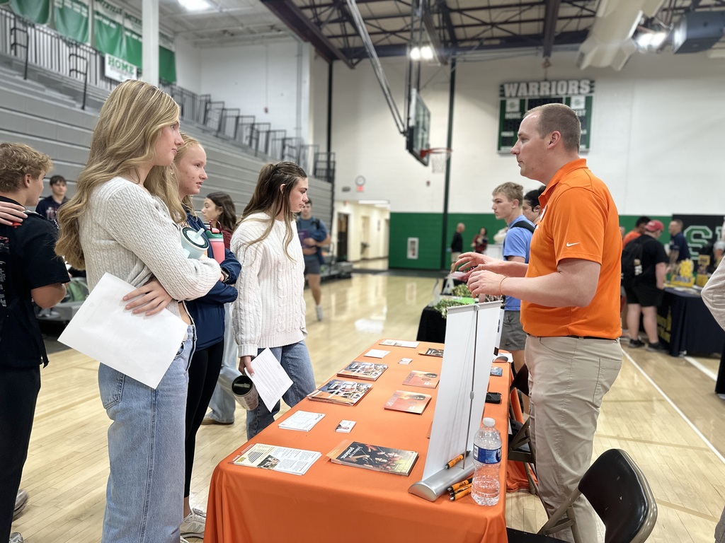 Students speak to the representative from a college.