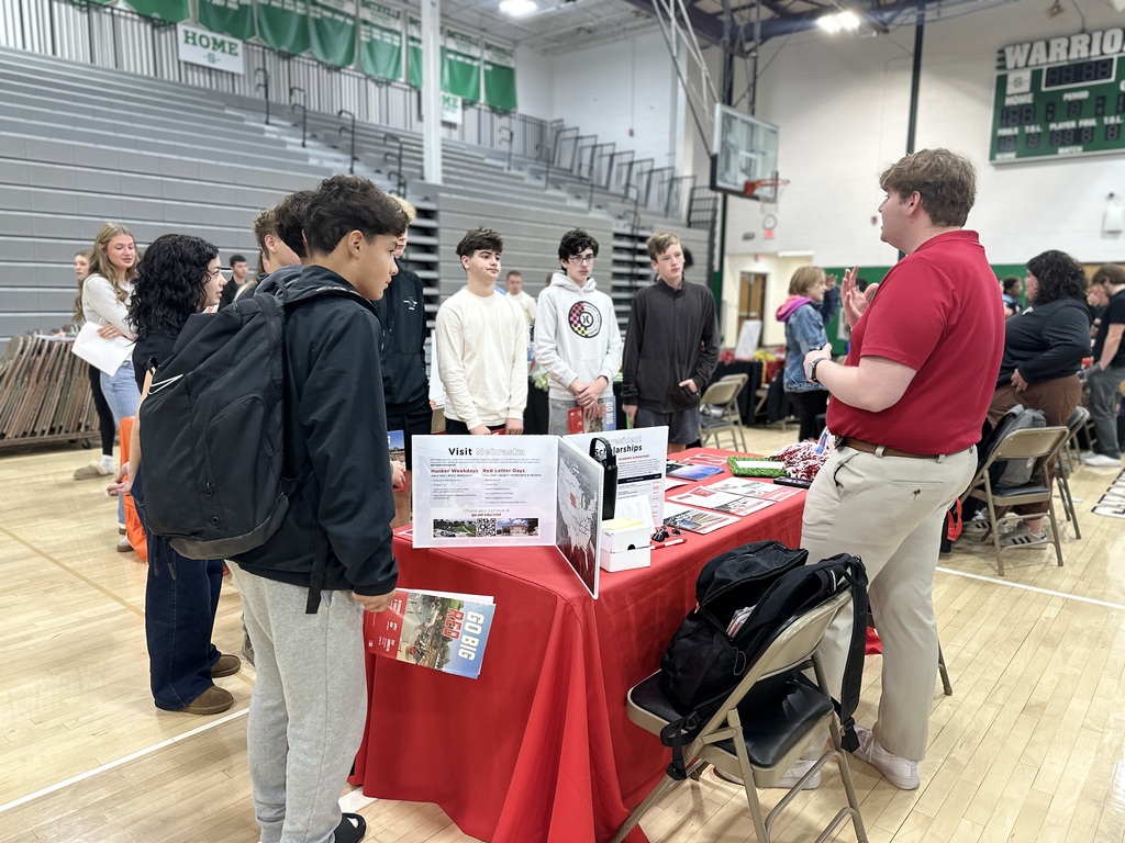 Students speak to the representative from University of Nebraska