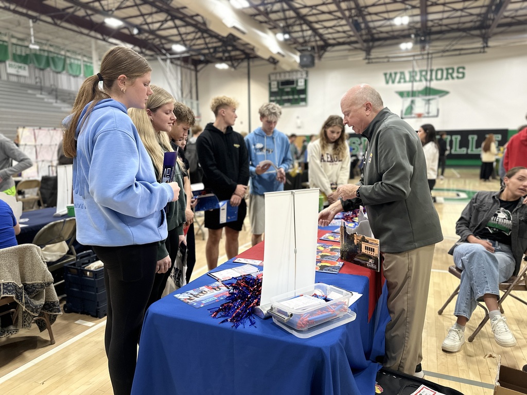 Students speak to the representative from University of Kansas.