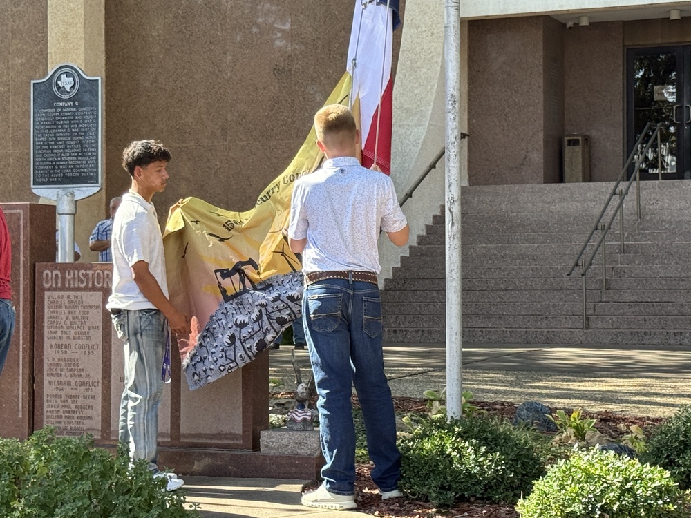 student raising flag