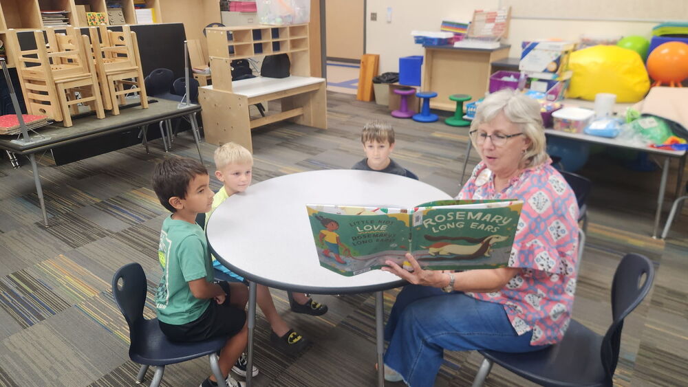 woman reading to students
