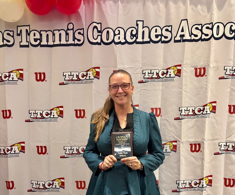 coach hale standing with trophy