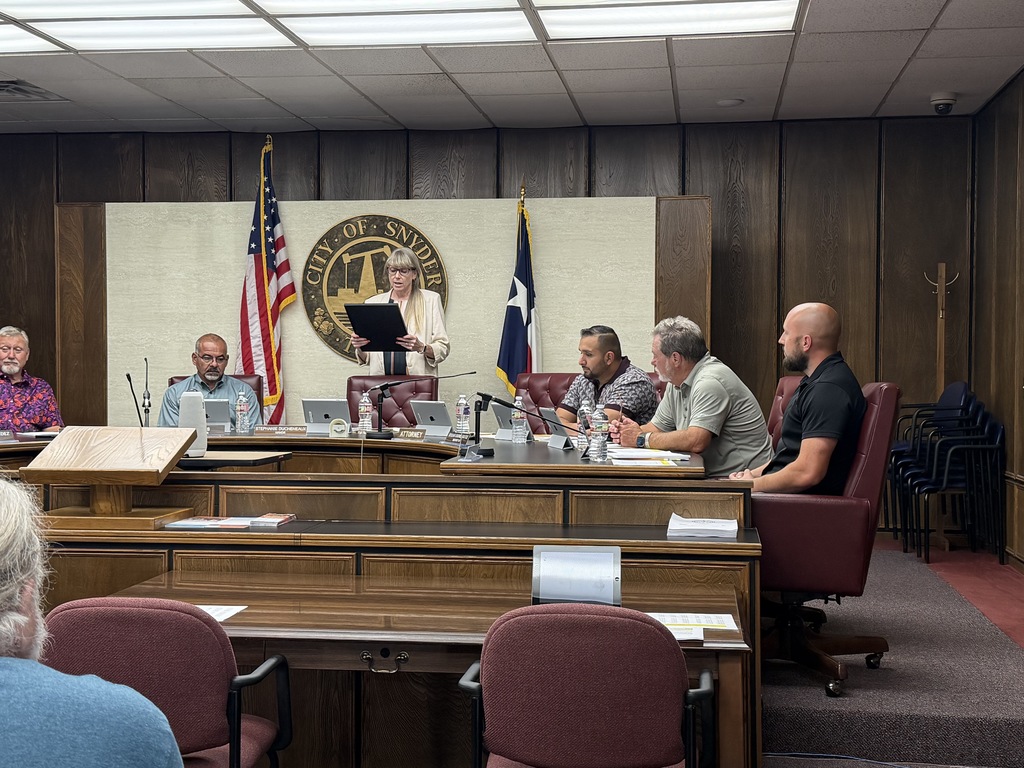 photo of mayor reading proclomation at meeting 