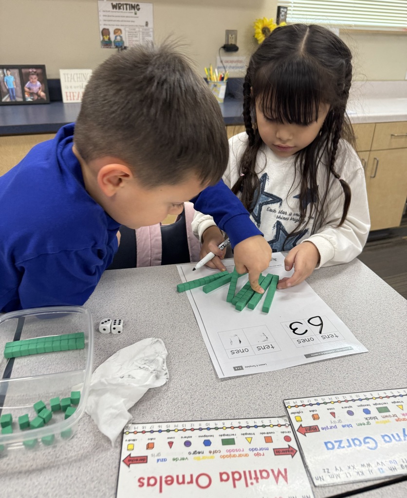 students working on math project together using dice and counting items