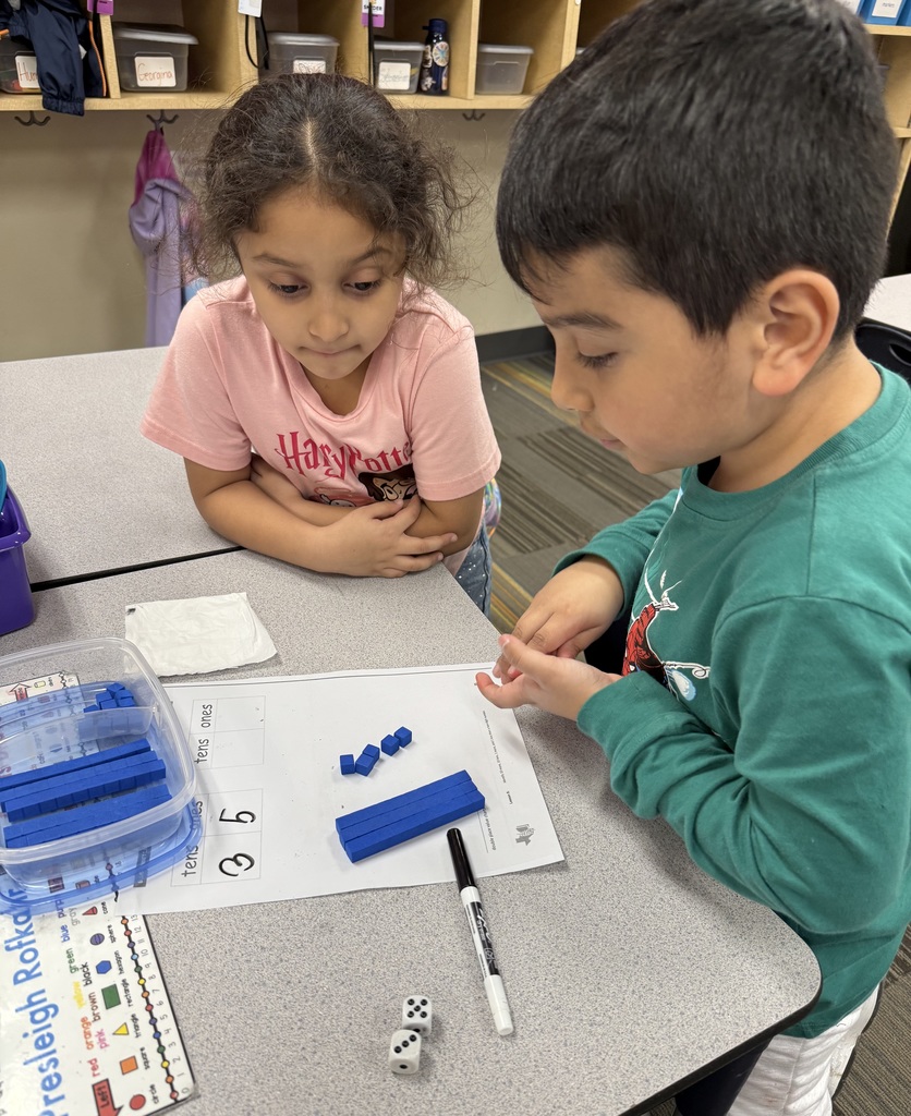 students working on math project together using dice and counting items