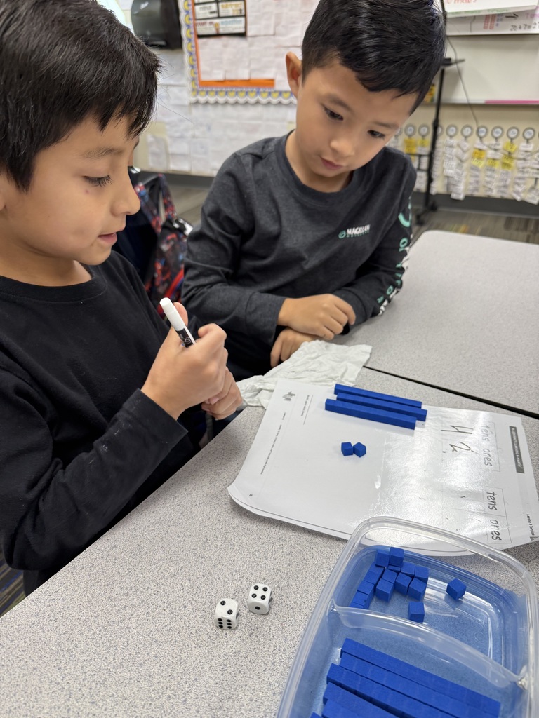 students working on math project together using dice and counting items