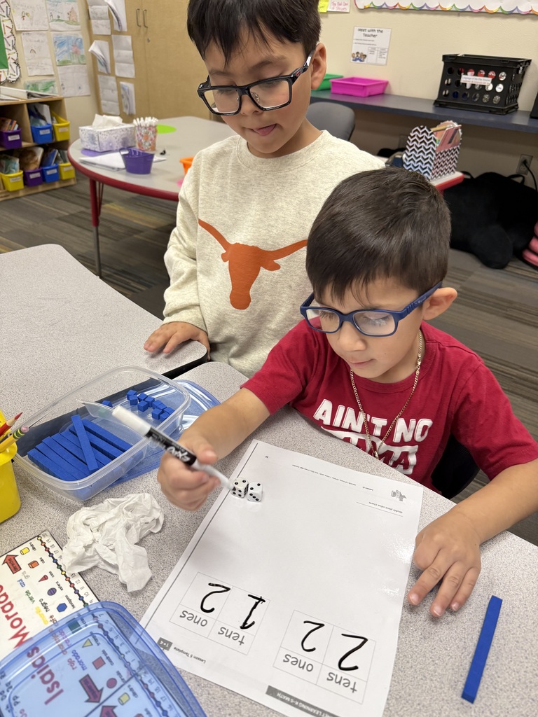 students working on math project together using dice and counting items