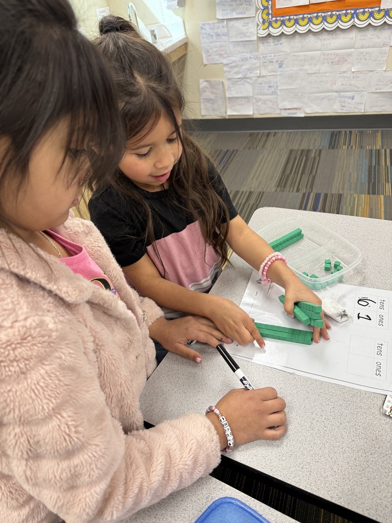 students working on math project together using dice and counting items