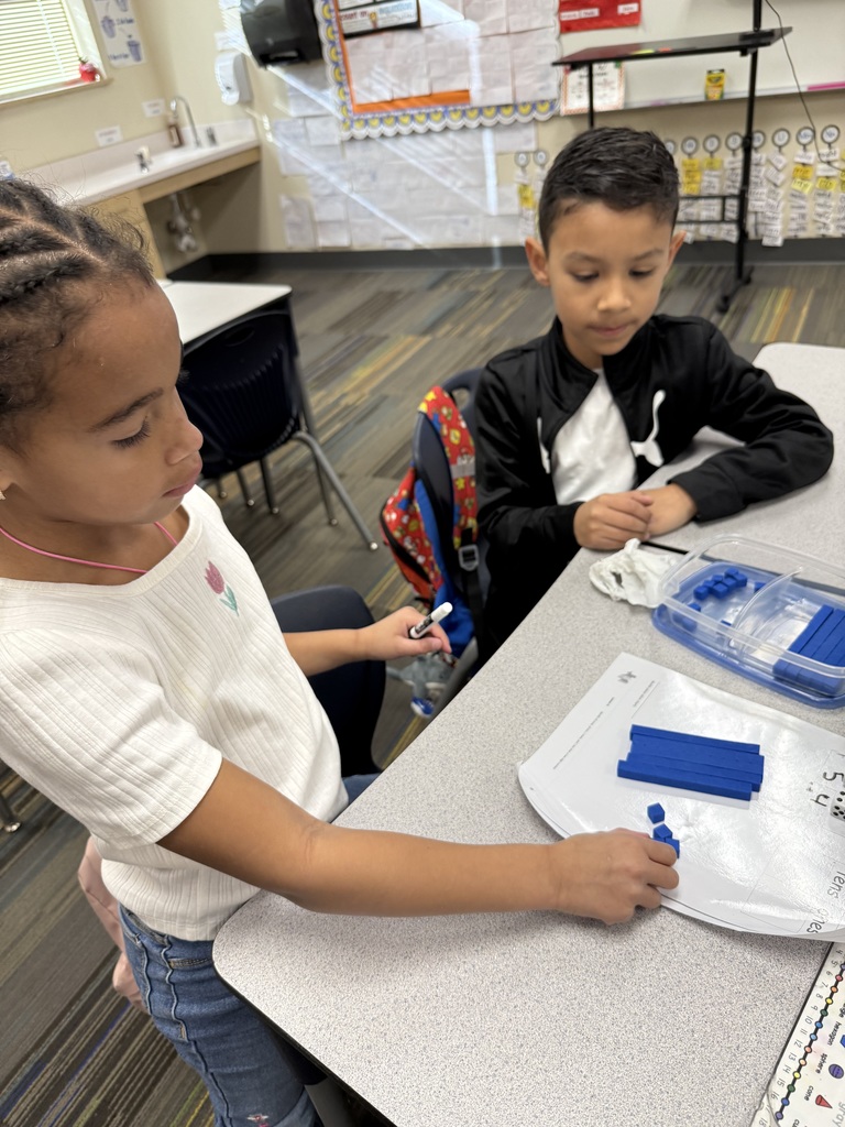 students working on math project together using dice and counting items