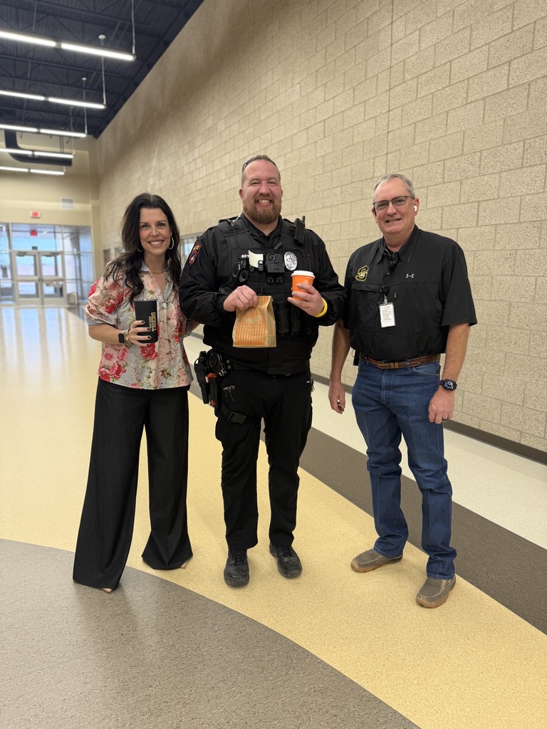 superintendent and director of security posing with school resource officer and whataburger!