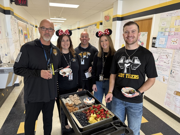 staff posing with instructional staff and mini treats