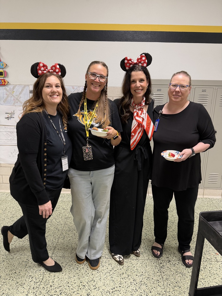 staff posing with instructional staff and mini treats