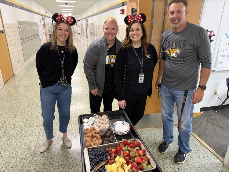 staff posing with instructional staff and mini treats
