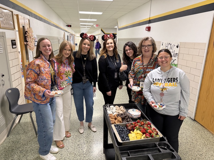 staff posing with instructional staff and mini treats