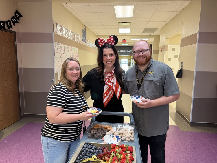 staff posing with instructional staff and mini treats