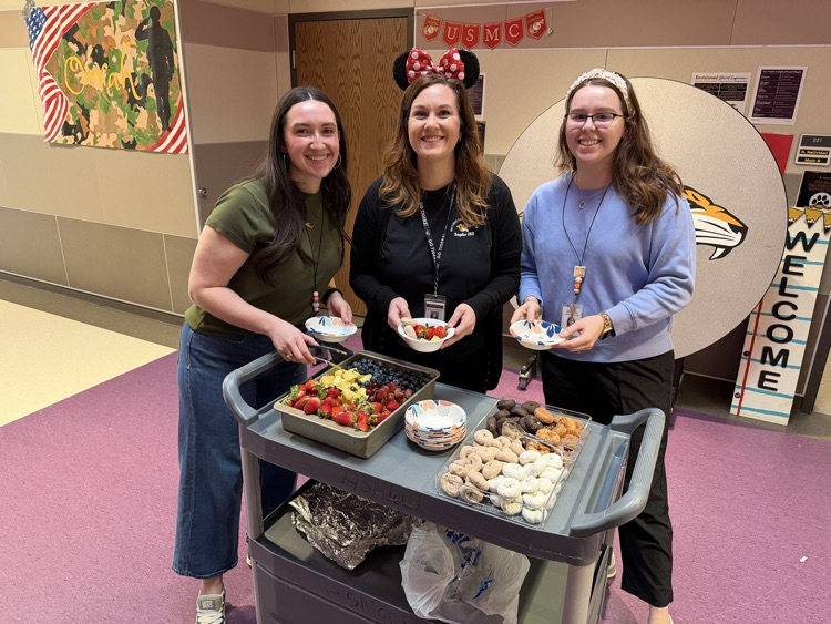 staff posing with instructional staff and mini treats