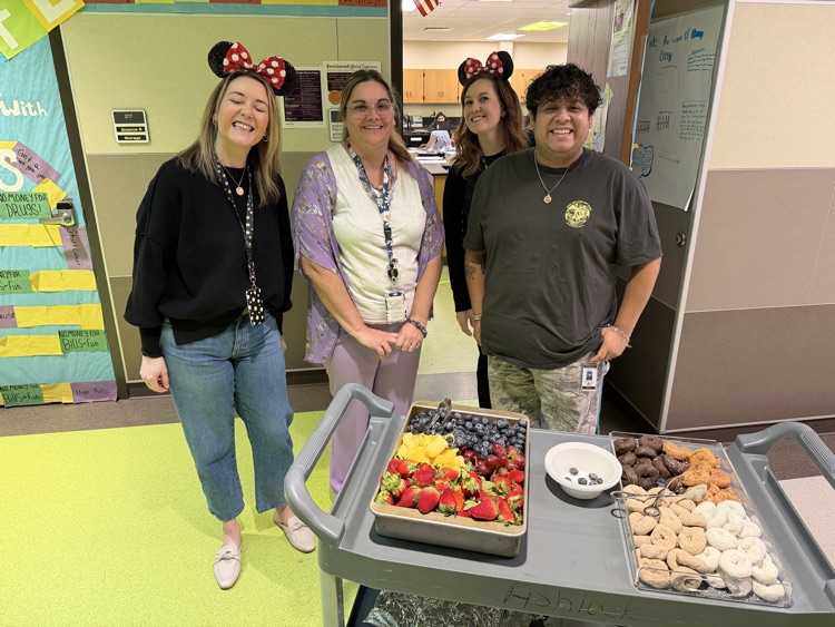 staff posing with instructional staff and mini treats