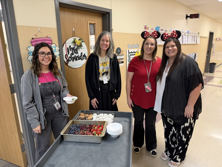 staff posing with instructional staff and mini treats