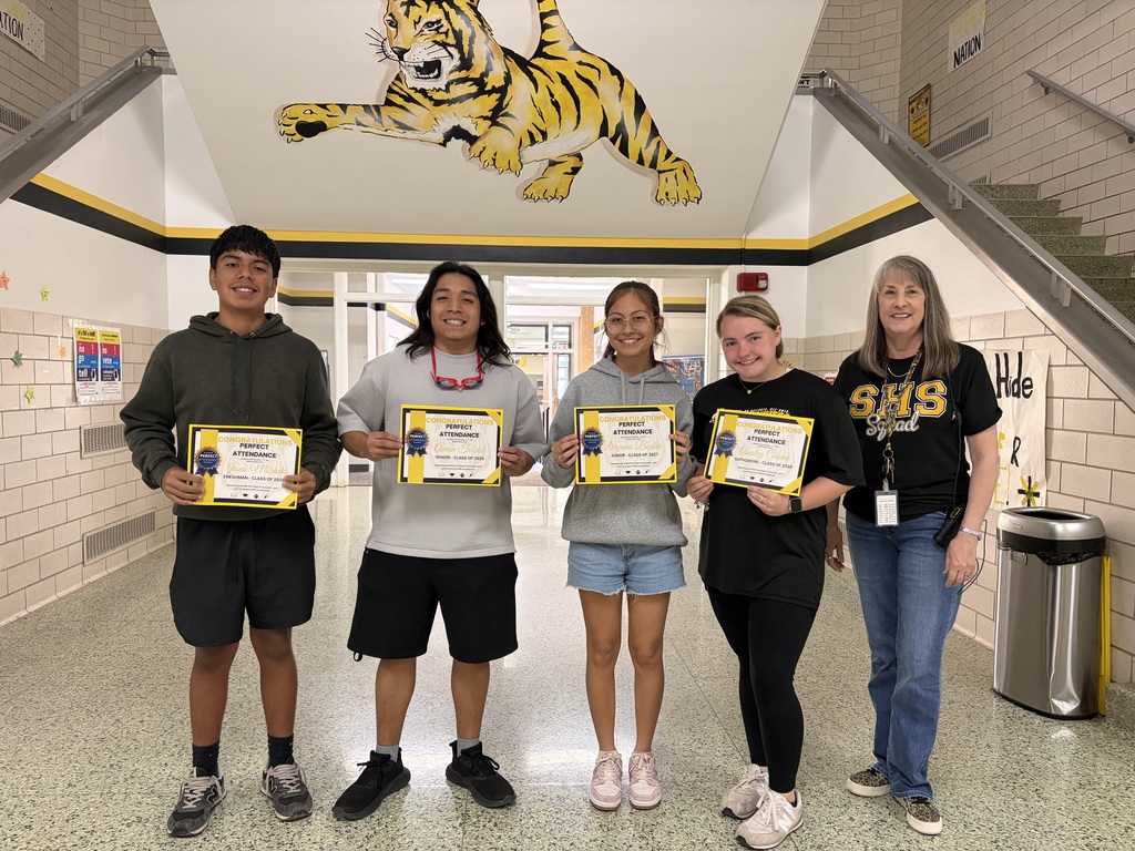 Students winning th eattendenace challenge and their certificates.